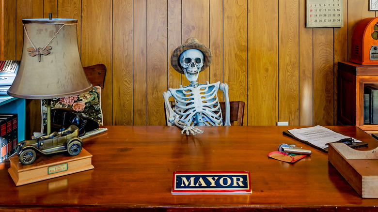 Skeleton sitting at mayor table exhibit at Fairhope Museum of History