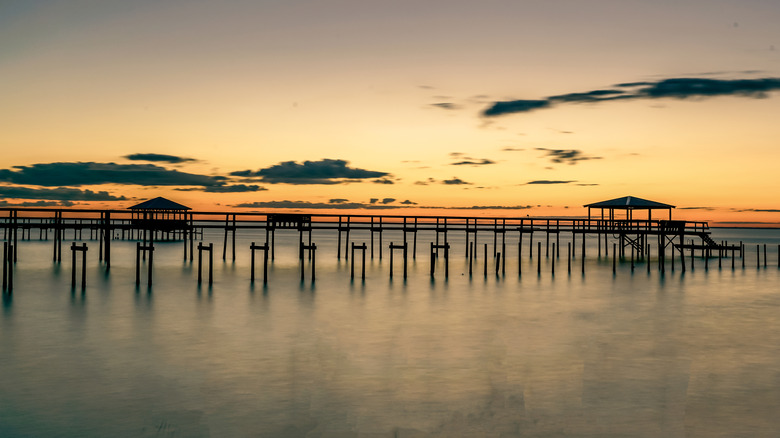 Sunset views over water and pier in Fairhope, Alabama