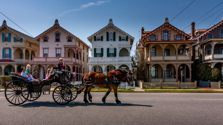 A horse-drawn carriage passes Victorian homes in Cape May