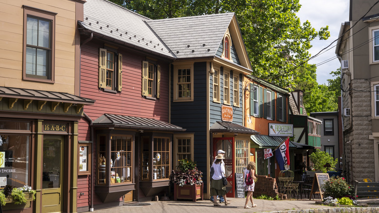 Colorful shops lining a sidewalk in Frenchtown with people walking