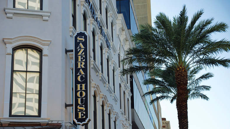 Exterior of Sazerac House with a sign and palm tree