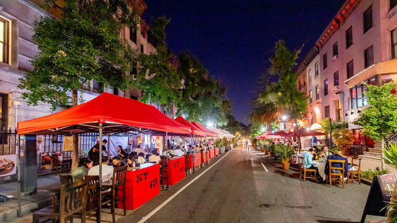 Sidewalk diners along Restaurant Row in New York City