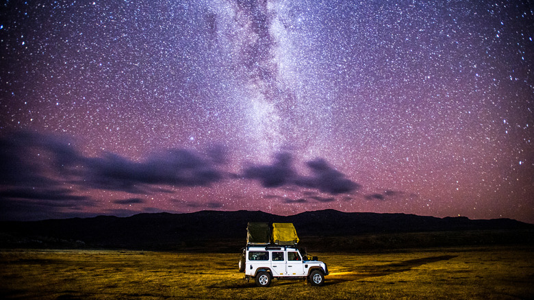 A Jeep touring under the Milky Way