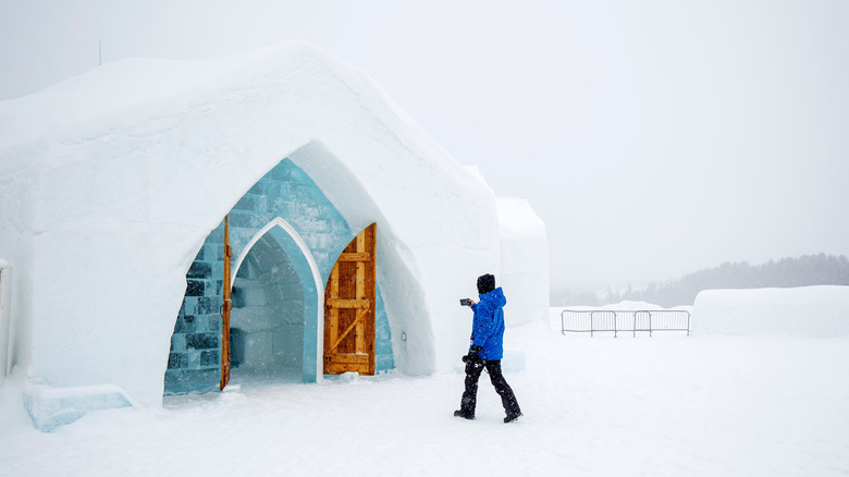 Man in blue jacket approaching the Hotel de Glace entrance in Quebec