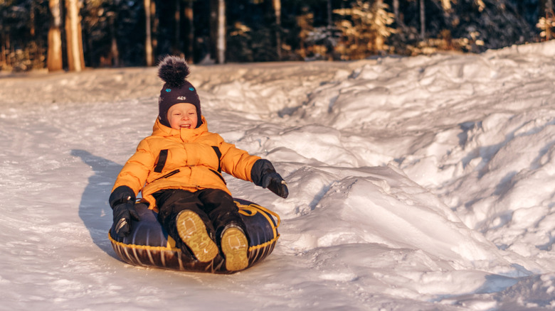 Kid tubing on snow in the winter