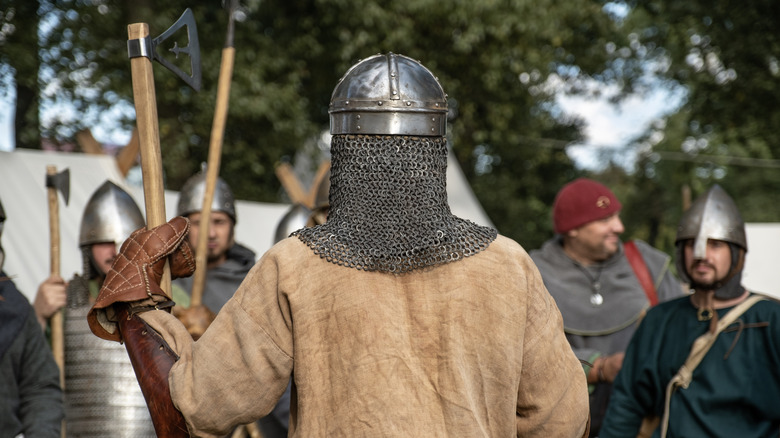 People dressed as Vikings with helmets and axes