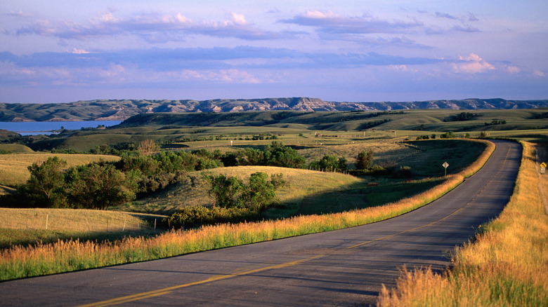 Highway lined by rolling hills in Bismarck, North Dakota