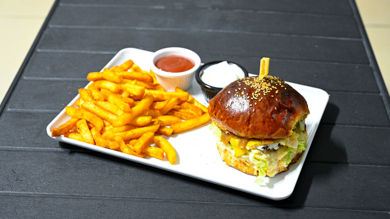 Burger and fries on tray with dip