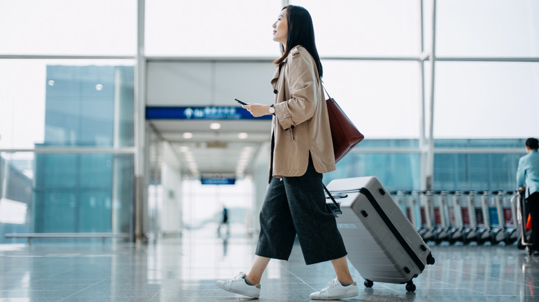 A traveler walking in an airport