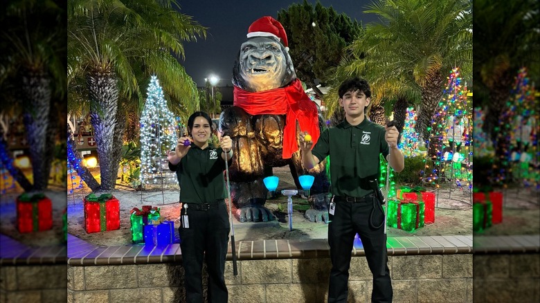 Golfland workers posing in front of holiday-themed decorations