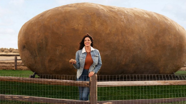 Owner, Kristie Wolfe, in front of the large potato