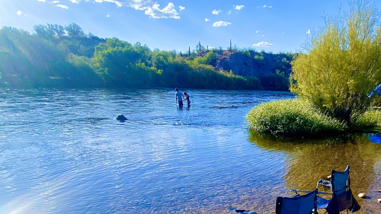 People wading in the Salt River at Pebble Beach in Arizona