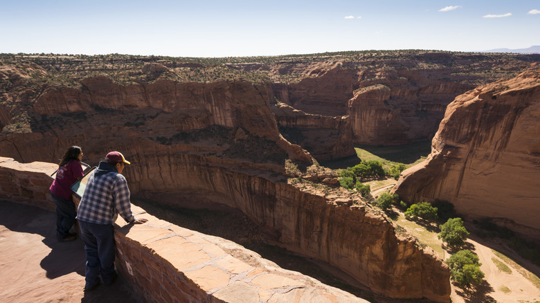 Visitors at an overlook at Canyon de Chelly