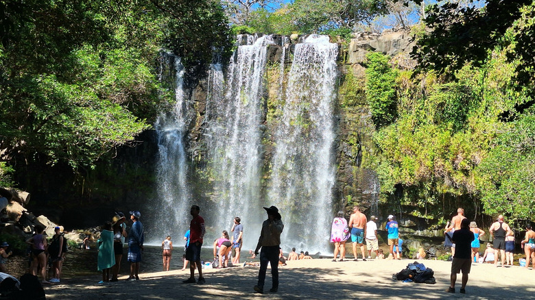 People standing on the beach near Llanos de Cortés waterfall