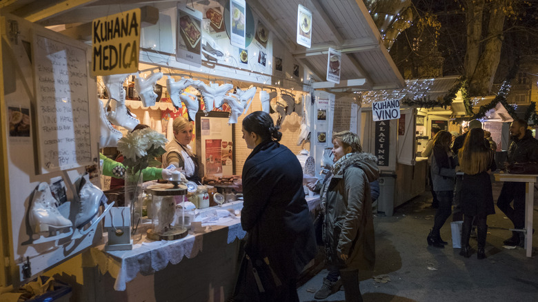 A woman buying something from a stall at a winter market in Zagreb.