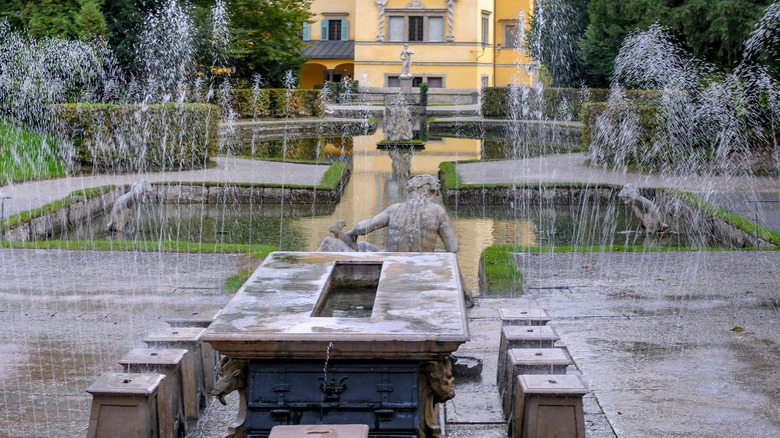 a fountain spraying water at Hellbrunn Palace