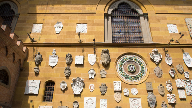 Plaques and coats of arms on the walls of the Stibbert Museum in Florence, Italy