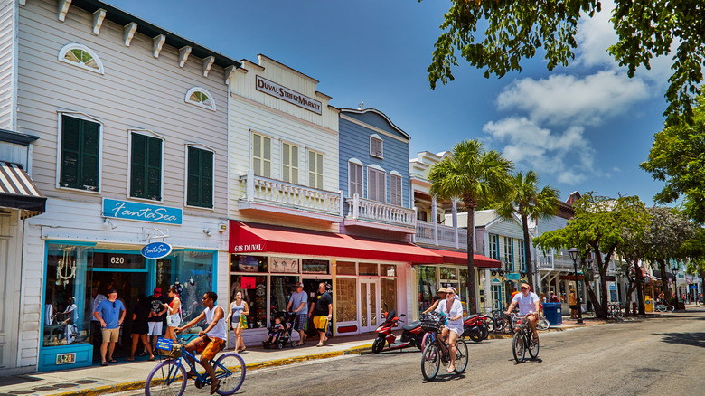 Key West street with shops and cyclists