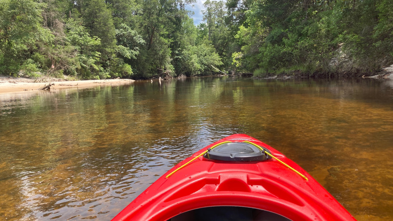 A red kayak floats down the Blackwater River near Milton, FL