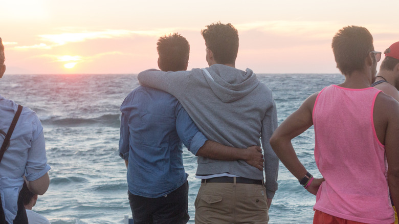 Gay couple watching the sunset in Mykonos, Greece