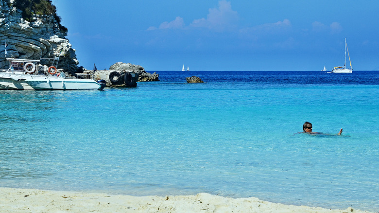 A swimmer surrounded by turquoise water at Vrika Beach in Greece