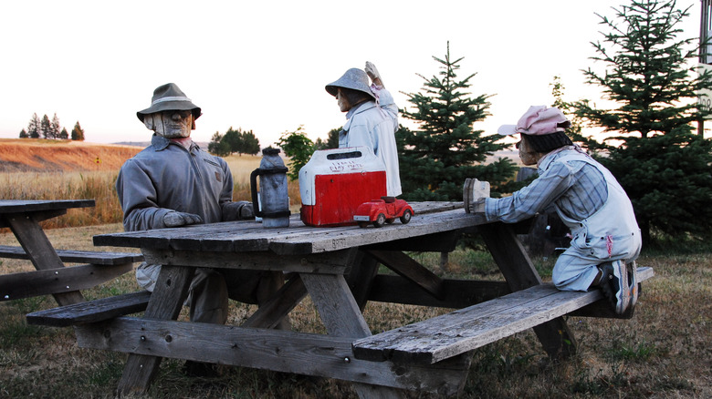 A sculpture of three men eating lunch, found at the Dog Bark Park