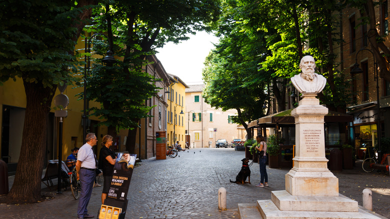 Cobbled street and statue in Pesaro, Italy