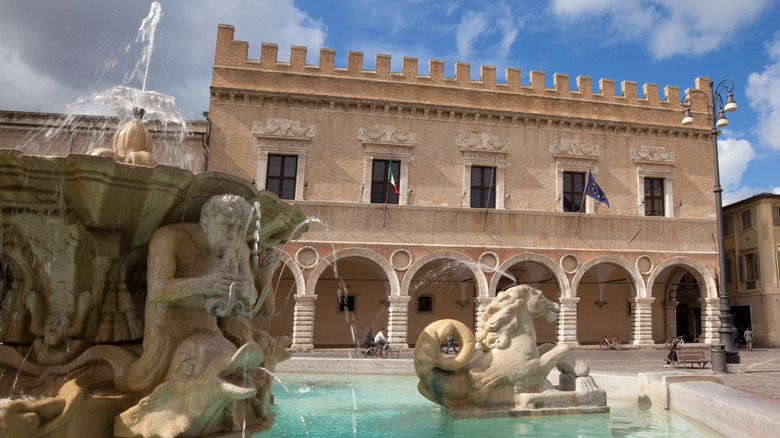 Fountain and palace in Pesano, Italy's old town square