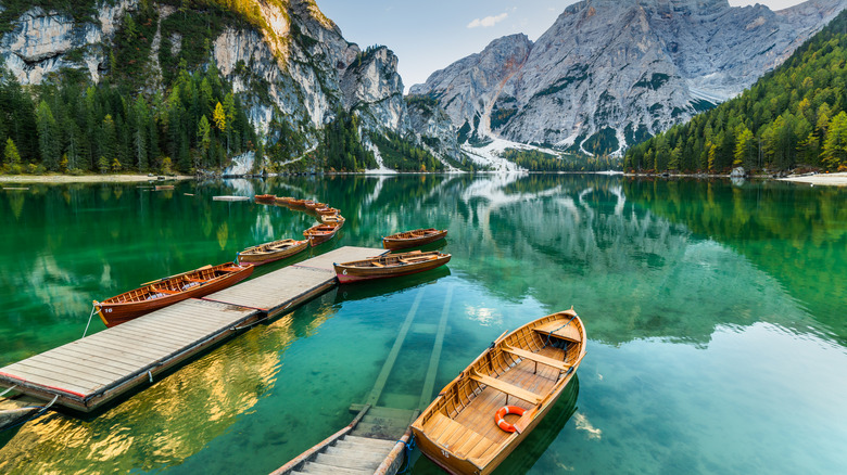 Row boats on the water at Lago di Braies with mountains in the backdrop