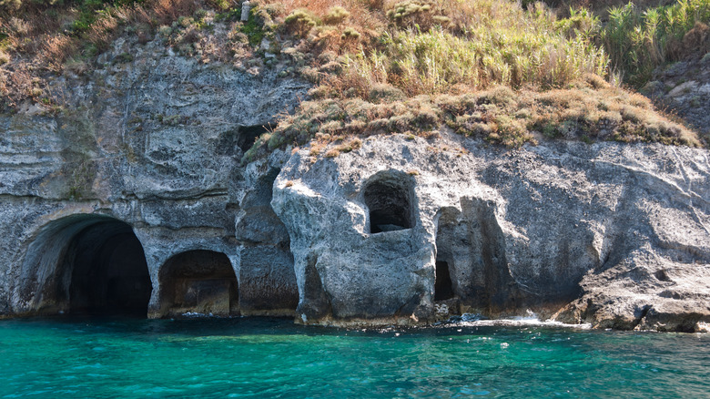 Carved cave grotto on the water