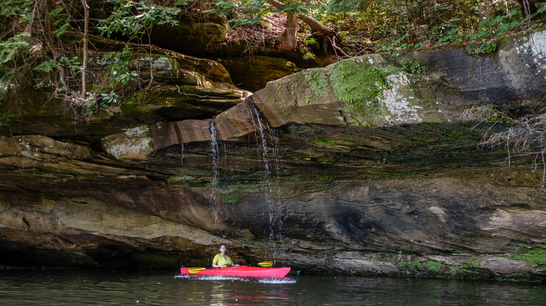 Kayaker before a small waterfall at Grayson Lake State Park