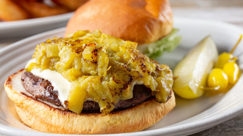 Cheeseburger topped with freshly roasted green chiles