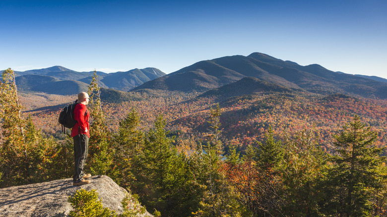 Hiker looking at the Adirondack Mountains in fall