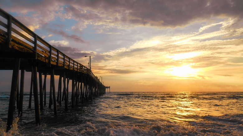 A pier stretching out into the ocean at sunrise