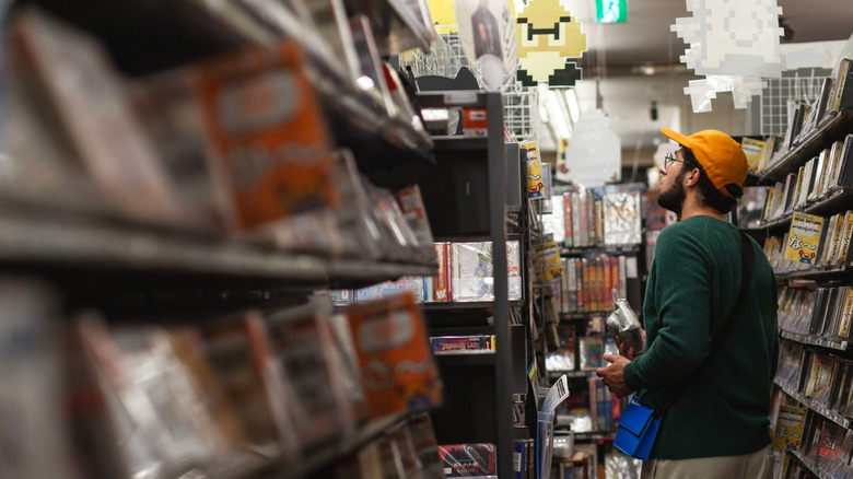 Man browsing through shelves in a video store