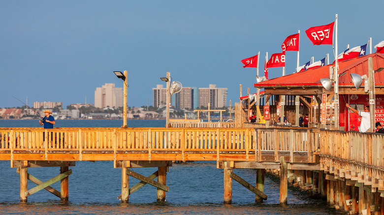 A man fishing on a wooden pier in Port Isabel