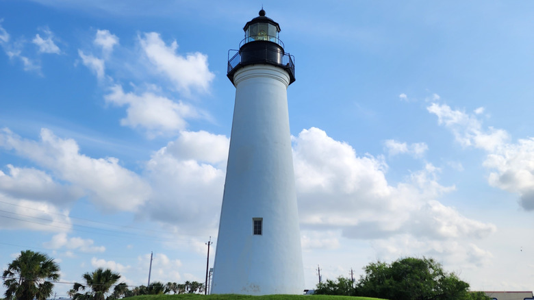 A ground view of the Port Isabel Lighthouse with clouds behind it