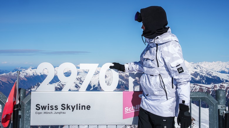 person standing at jungfrau mountain peak in Switzerland