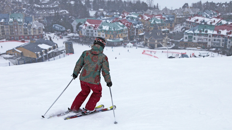 View of skier skiing down mountain to Tremblant vollage