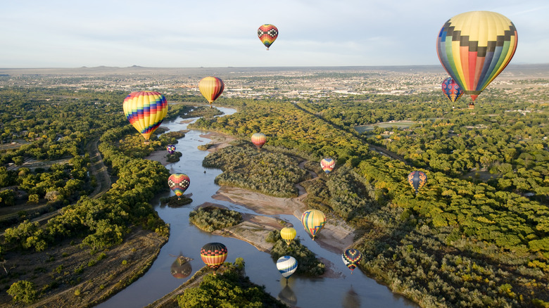 Hot air balloons over river