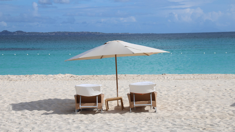 Beach chairs on white-sand beach