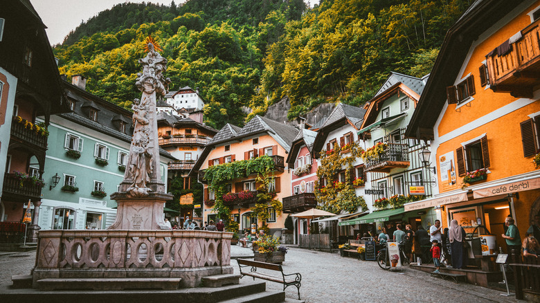 Hallstatt Marktplatz with a statue and colorful buildings in Hallstatt, Austria