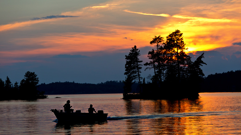 People boating on a lake near Ely, Minnesota, at sunset