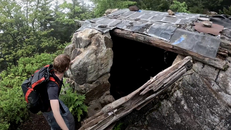 A hiker enters Pumpelly Cave