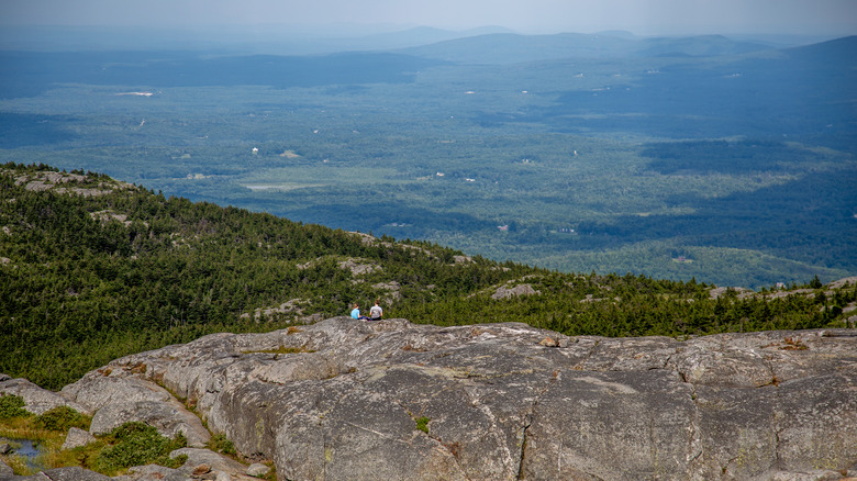 Two hikers at the very top of Mount Monadnock