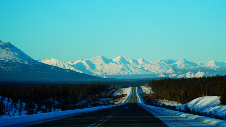 The Yukon side of Haines Highway with snowy mountains in the distance