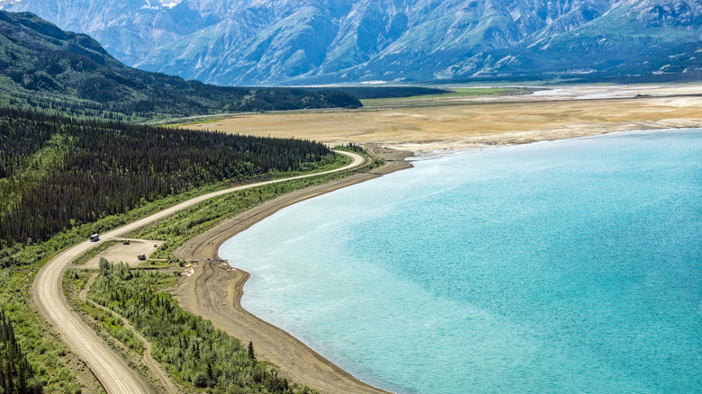 A lake surrounded by mountains in Yukon, Canada