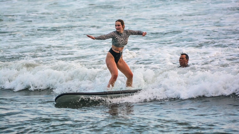 Woman surfing at Pererenan Beach