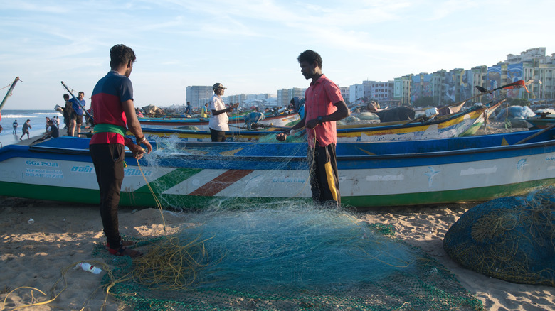 Fishermen organizing nets at Marina Beach