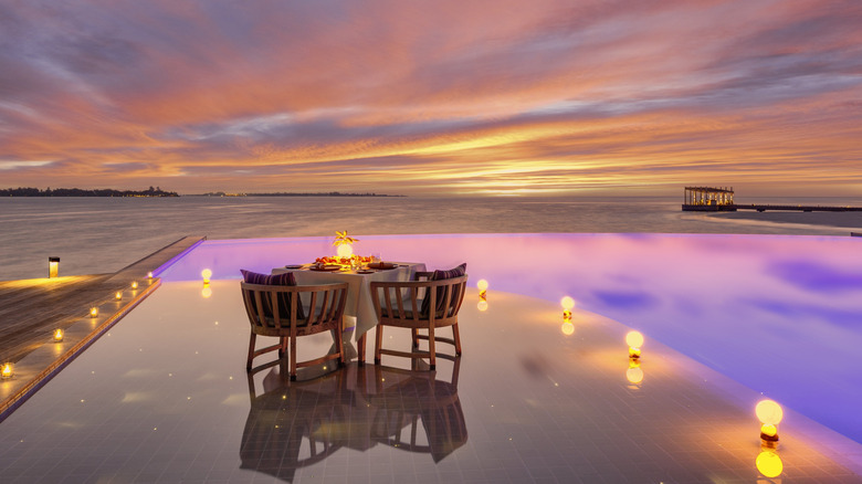 Sunset dining over the water at Kudadoo Private Island by Hurawalhi in the Lhaviyani Atoll in the Maldives